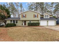 Charming two-story home with a welcoming front yard and a two-car garage at 7612 Harps Mill Rd, Raleigh, NC 27615