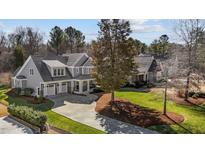 Beautiful two-story home with a charming covered front porch and manicured lawn at 818 Cabin Creek, Pittsboro, NC 27312