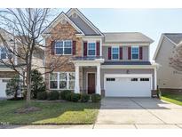 Charming two-story home with stone accents, landscaped yard, and a two-car garage at 2109 Royal Berry Ct, Cary, NC 27511