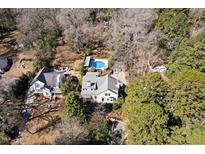 A beautiful home featuring a large pool and a spacious yard, as seen from an aerial view at 2610 University Dr, Durham, NC 27707