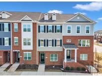 Charming townhomes showcasing brick and siding exteriors with inviting entryways and well-maintained landscaping at 507 Gateway Townes Blvd, Wake Forest, NC 27587