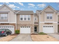Charming townhome featuring a one-car garage, brick accents, and neutral siding in a well-maintained community at 705 Keystone Park Dr # 51, Morrisville, NC 27560