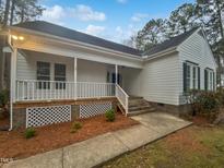 Charming single-story home with a welcoming front porch and well-maintained landscaping at 900 Oakwater Dr, Garner, NC 27529