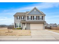 Charming two-story home features a two-car garage and a well-manicured lawn at 1 Baylis St, Franklinton, NC 27525