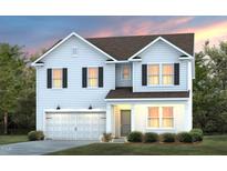 Charming two-story home with a two car garage and beautifully manicured front yard at 1003 Freestone Rd, Durham, NC 27703