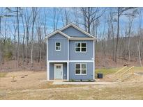Charming two-story home features a blue exterior, white trim, and an inviting front entrance at 181 Royal St, Fuquay Varina, NC 27526