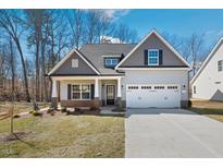 Charming craftsman-style home with a two-car garage, inviting front porch and manicured lawn at 1991 Meadowview Dr, Graham, NC 27253
