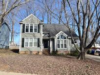 Charming two-story home with gray siding and a well-manicured front yard at 2813 Hiking Trail Trl, Raleigh, NC 27615