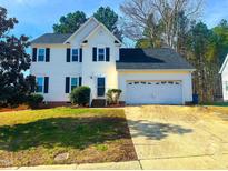 Charming two-story home with black shutters, attached garage, and well-maintained front lawn at 401 Maymount Dr, Durham, NC 27703