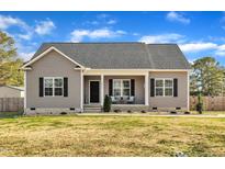 Charming single-story home with gray siding, black shutters, and a cozy front porch at 591 Mckay St, Erwin, NC 28339