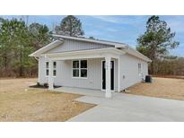 Charming home featuring a well-maintained yard and modern architectural details at 704 East St, Smithfield, NC 27577