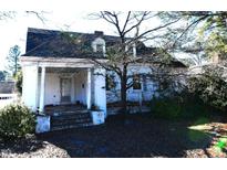 Charming two-story home with a columned front porch and mature tree at 1101 Sunset Ave, Rocky Mount, NC 27804