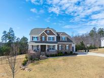 Charming two-story home with a manicured lawn, stone accents, and a welcoming front porch at 158 Futrell Ridge Ct, Chapel Hill, NC 27517