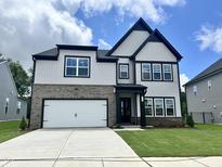 Beautiful two-story home with a brick and siding exterior, attached garage, and well-manicured lawn at 167 S Harvest Ridge Way # Homesite 223, Wilson's Mills, NC 27520