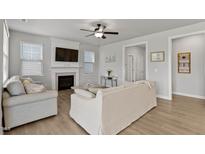 Bright living room features a fireplace, ceiling fan, and cozy seating at 1872 Stagecoach Trl, Wendell, NC 27591