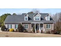 Charming single-story home featuring a stone facade, dormer windows, and a well-maintained front yard at 2570 Sweet Bay Rd, Rocky Mount, NC 27804
