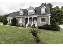 Charming two-story home with stone accents, dormers, and a welcoming front porch at 2570 Sweet Bay Rd, Rocky Mount, NC 27804