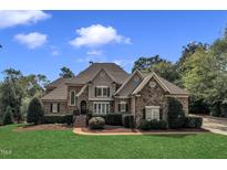 Beautiful brick home with stone accents, manicured landscaping, and a welcoming front entrance at 2608 Prosser Ct, Raleigh, NC 27614