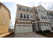 New construction townhouse with a two-car garage and stone and siding facade at 2715 Hunter Woods Dr # 562, Apex, NC 27502
