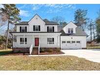 Charming two-story home with a inviting front porch and a well-manicured lawn at 286 Audrey Cir, Garner, NC 27529