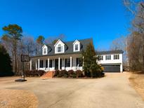 Charming two-story home featuring a wide front porch with columns and a basketball court at 42 Miry Branch Ct, Garner, NC 27529