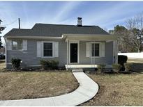 Charming home with a curved walkway, light gray siding, and a covered front porch at 4319 Denfield St, Durham, NC 27704