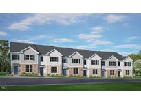 New townhome community showcasing brick and light siding with dark shutters and a beautifully landscaped front yard at 521 Old Battle Bridge Rd, Wendell, NC 27591