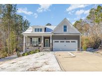 Charming home featuring a manicured lawn and inviting front porch at 96 Linda Lou Ln, Angier, NC 27501
