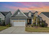 Charming single-Gathering home with a two-car garage, manicured lawn, and craftsman-style architectural details at 1221 Ballerina Ln, Durham, NC 27703