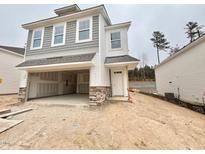 Two-story home featuring a two-car garage, white siding, shingle details, and a welcoming front door at 132 Muskogee Rd # 58, Angier, NC 27501