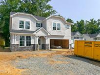 New construction home featuring gray stone accents and open garage awaiting your personal touches at 1905 Old Bramble Ln # 4, Fuquay Varina, NC 27526