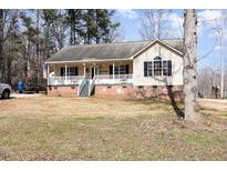Charming single-story home with a welcoming front porch and brick foundation at 2021 Messer Rd, Raleigh, NC 27603
