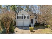 Charming two-story home with a two-car garage, a welcoming front porch, and dark shutters at 224 Hartshorn Ct, Holly Springs, NC 27540