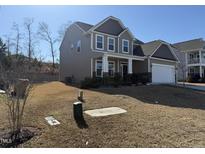 Charming two-story home featuring a covered front porch and attached two-car garage at 257 Cliffview Dr, Garner, NC 27529