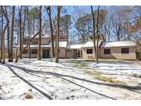 Inviting two-story home nestled in a snow-covered landscape, surrounded by mature trees at 316 Russ Rd, Smithfield, NC 27577
