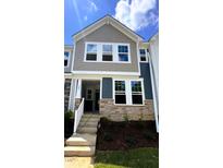 Charming two-story townhome showcasing stone accents, neutral siding, and bright white trim at 328 Church St # 43, Wendell, NC 27591