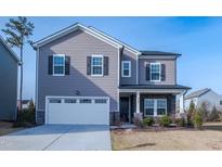 Charming two-story home with gray siding, white trim, black shutters, and a well-maintained front yard at 3505 Norway Spruce Rd, Raleigh, NC 27616