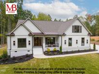 Charming single-story home boasts manicured lawn, covered entry, and a harmonious blend of materials for an inviting curb appeal at 4622 Durham Rd, Wake Forest, NC 27587