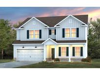 Charming two-story home featuring a classic design, a welcoming front porch, and a two-car garage at 1018 Freestone Rd, Durham, NC 27703