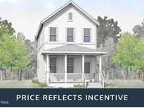 Charming two-story home featuring a covered front porch and classic architectural details at 1556 Piney Falls Dr, Wendell, NC 27591