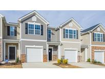 Charming townhouse featuring an attached one car garage and neutral siding at 1914 Frost Dr, Haw River, NC 27258