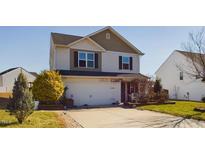 Charming two-story home with a two-car garage and well-maintained lawn at 218 Pillow Ln, Burlington, NC 27217
