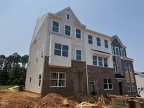 New construction townhome showcasing brick and siding facade with large windows at 312 Chesapeak Commons St # 144, Garner, NC 27529