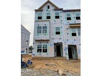 A townhome under construction featuring multiple windows ready for finishing details at 312 Chesapeak Commons St # 144, Garner, NC 27529