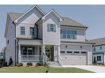 Charming two-story home featuring a welcoming front porch and attached two-car garage at 3521 Amelia Grace Dr # 67, Fuquay Varina, NC 27526