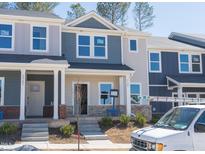 Charming new construction townhome with eye-catching brick accents and a welcoming covered porch at 3725 Rosebush Dr, Zebulon, NC 27597