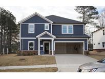 New two-story home featuring blue siding, white trim, and a two-car garage in a suburban neighborhood at 3813 Rosebush Dr, Zebulon, NC 27597