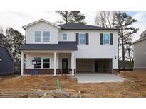 New two-story home featuring a two-car garage, black shutters, white siding, and a covered front porch at 3817 Rosebush Dr, Zebulon, NC 27597