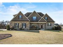 Charming two-story home featuring a stone facade and manicured front yard at 50 Setter Ct, Angier, NC 27501