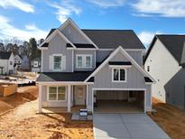 New two-story home with gray siding, black roof, and an attached two-car garage at 5161 Church Rd # 17, New Hill, NC 27562